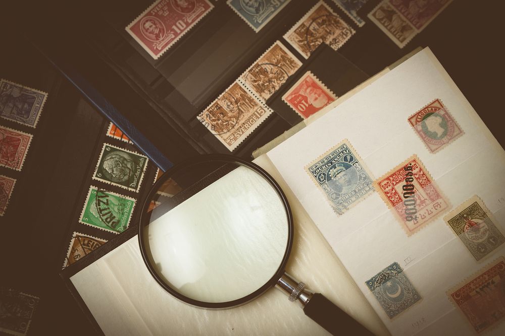 A vintage stamp album with a magnifying glass