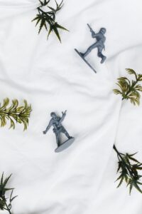 Loose plastic toy figures arranged on a light backdrop