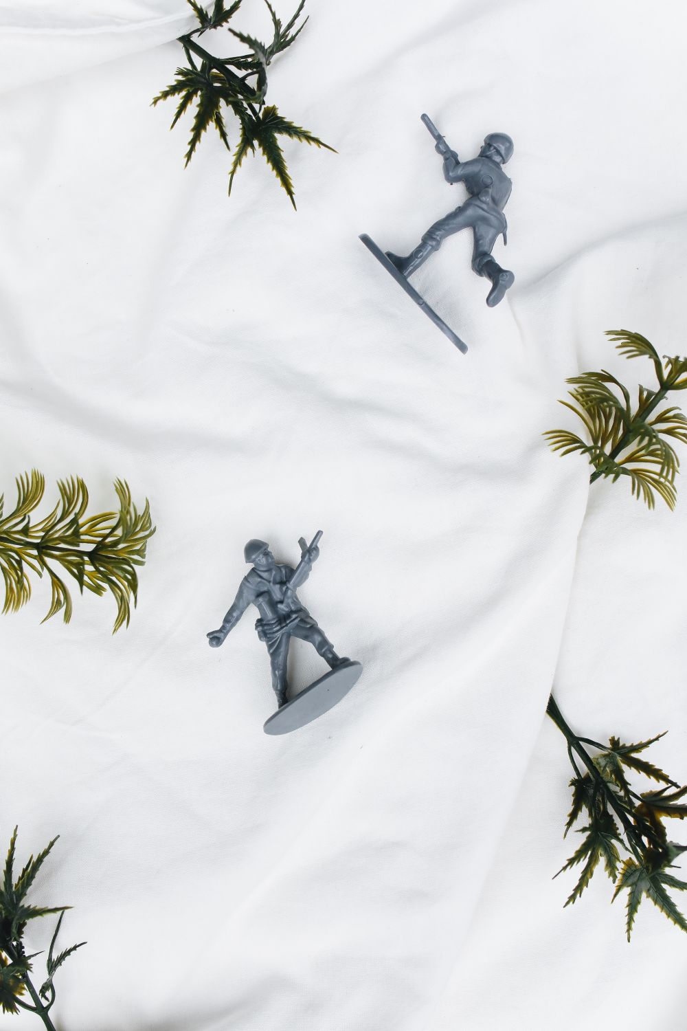 Loose plastic toy figures arranged on a light backdrop