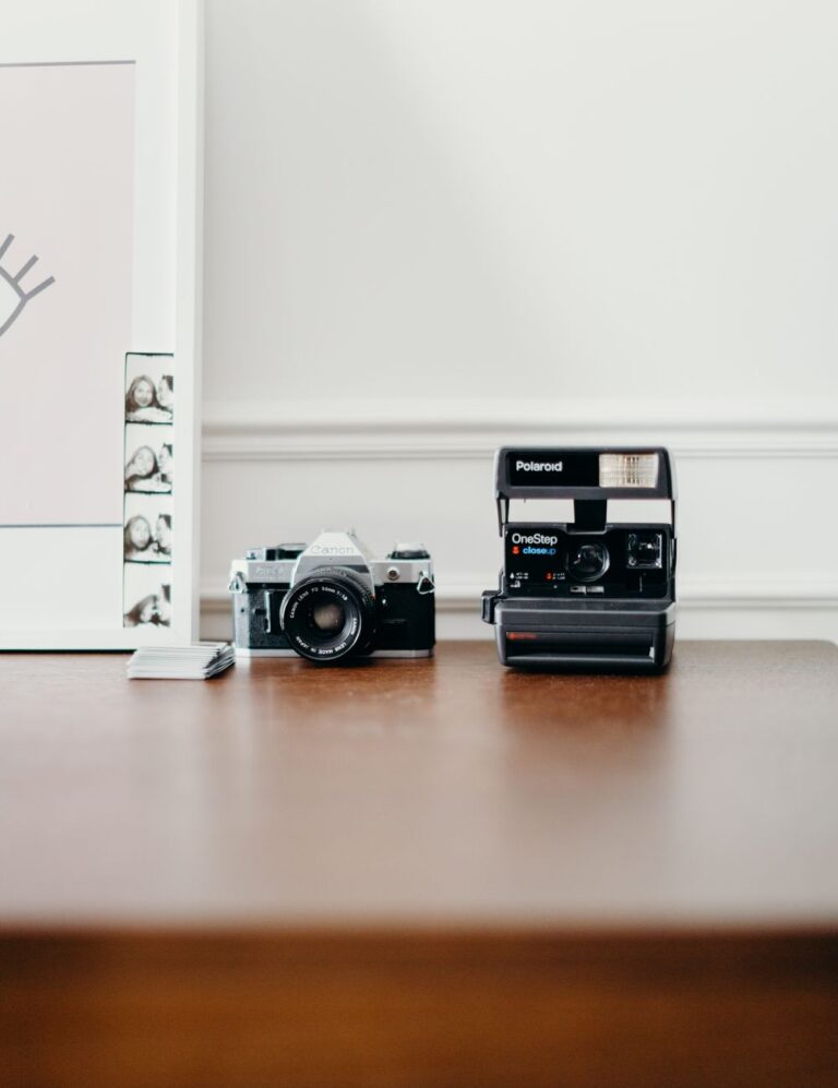 An old SLR and an instant camera on a table