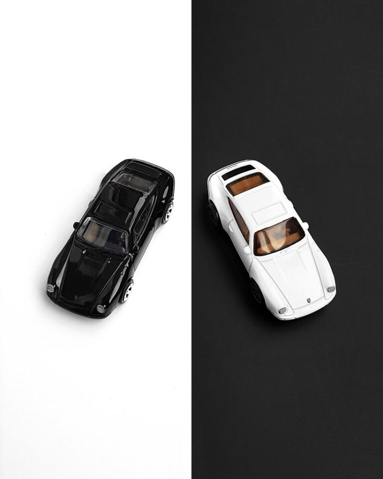 Two die-cast cars of the same model in different colors