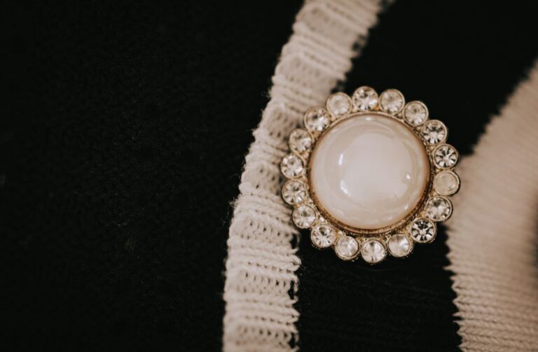A vintage rhinestone costume brooch on dark fabric