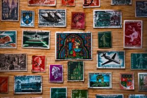 A grid of vintage postage stamps on a wooden surface