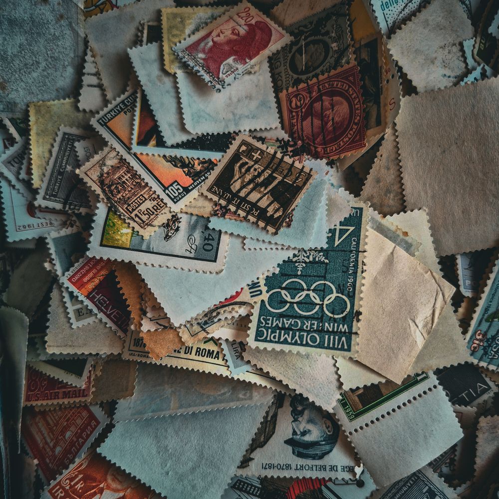 A jumbled pile of vintage postage stamps